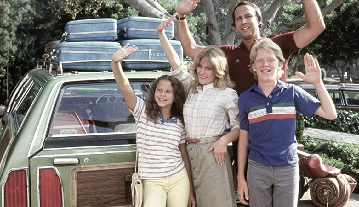This family standing in front of car packed for summer vacation knows that fly drvn long distance car service is the way to relax.