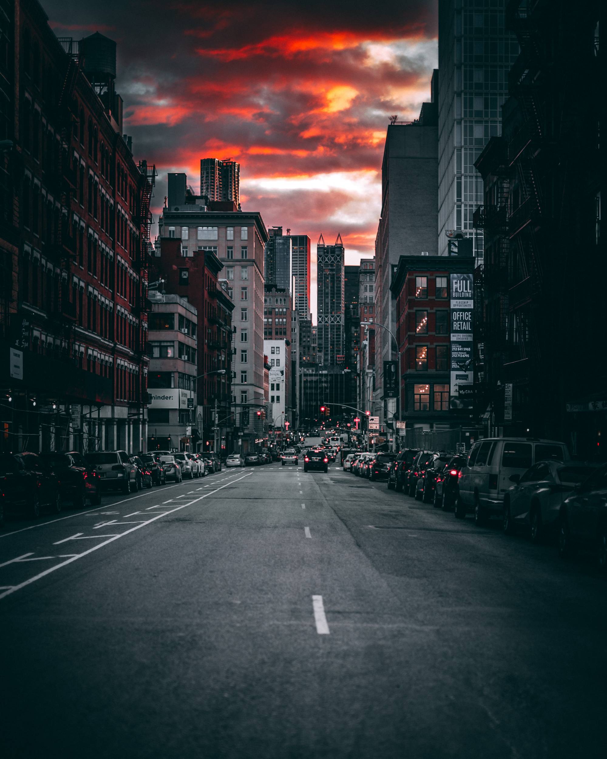 This NYC street at sunset is colorful and bustling. Experience the beauty of any city with drvn global chauffeured service.