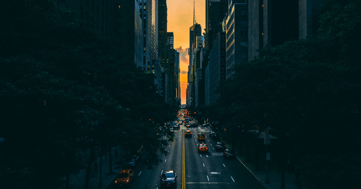 Chauffeur vs driver as the sun sets between skyscrapers in New York City
